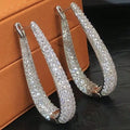 A pair of stylish and elegant high-end stud earrings with a dazzling and light luxury style sparkle effect