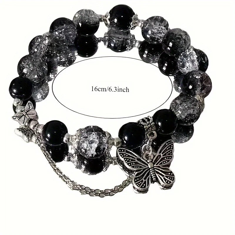 A black beaded bracelet with bohemian style, adorned with silver butterfly pendants and chain details.